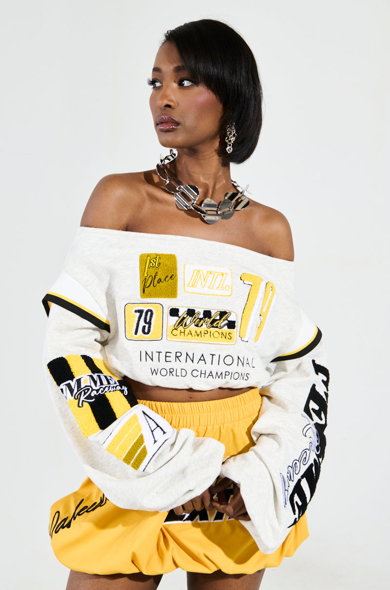 RACING THROUGH OFF THE SHOULDER SWEATSHIRT